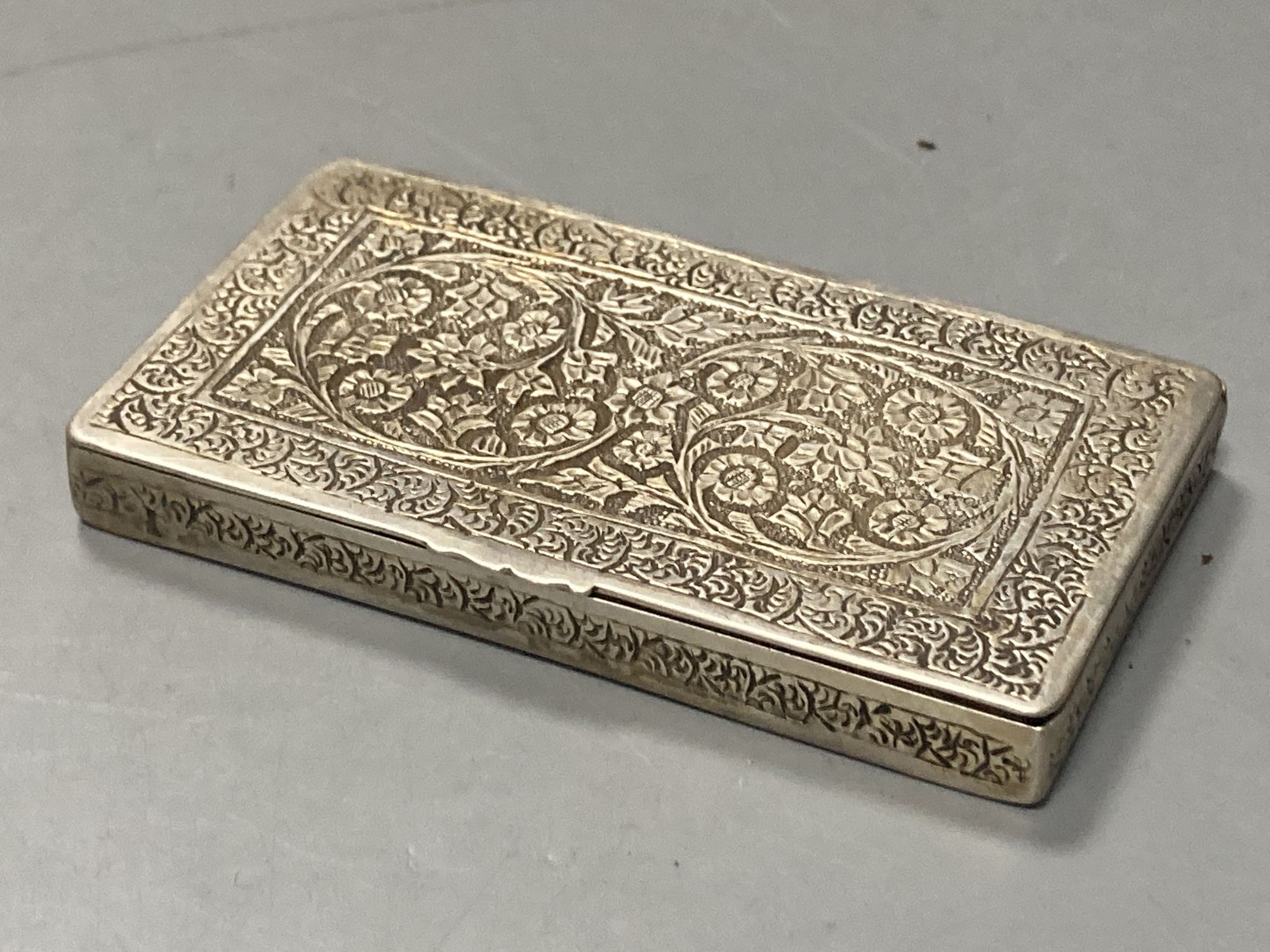 Two Chinese white metal filigree card cases, one with enamel(a.f.) & an Indian white metal snuff box, largest 91mm.